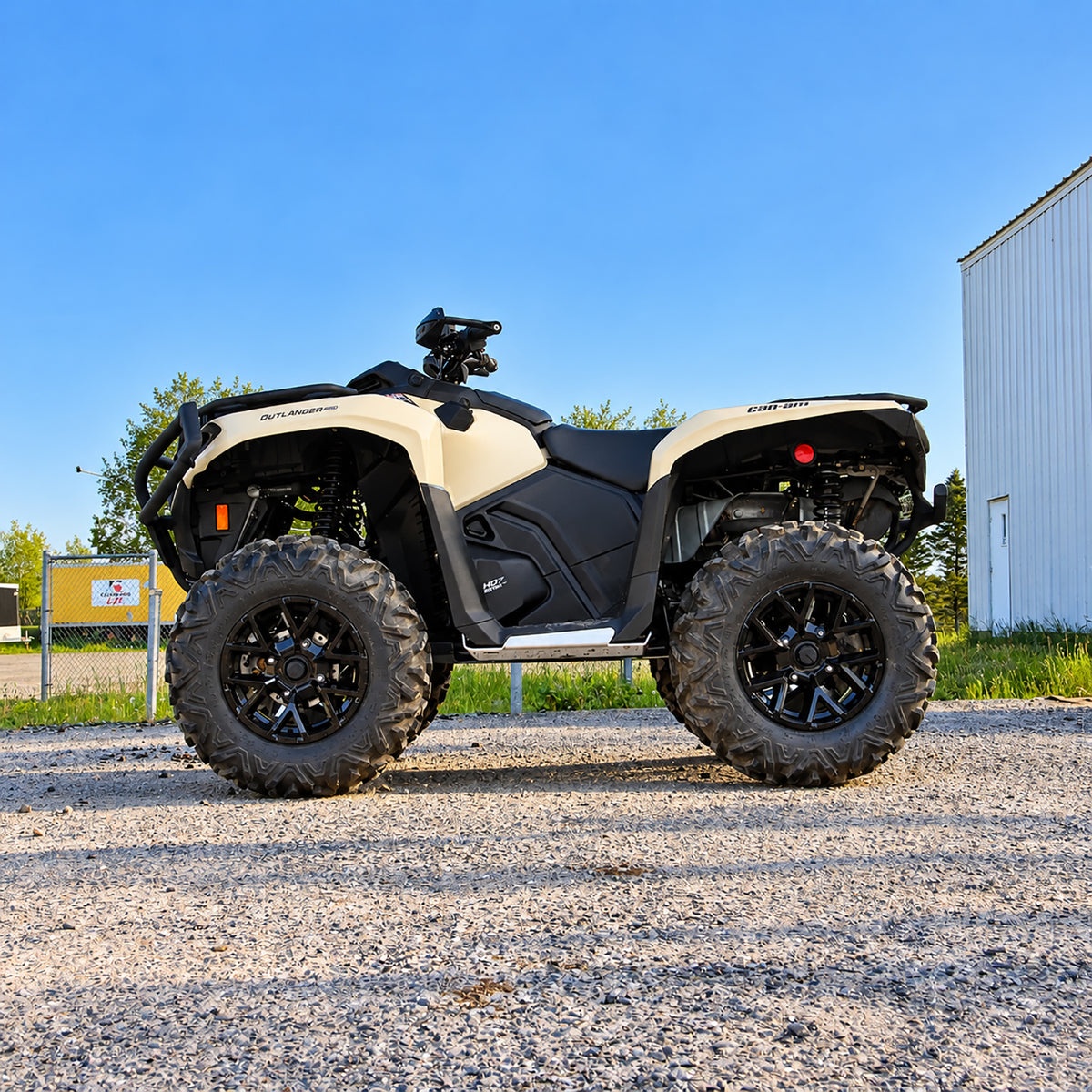 Side view of a Can-Am Outlander 700 PRO with PERFEX 1-inch lift kit installed, showing increased ground clearance.