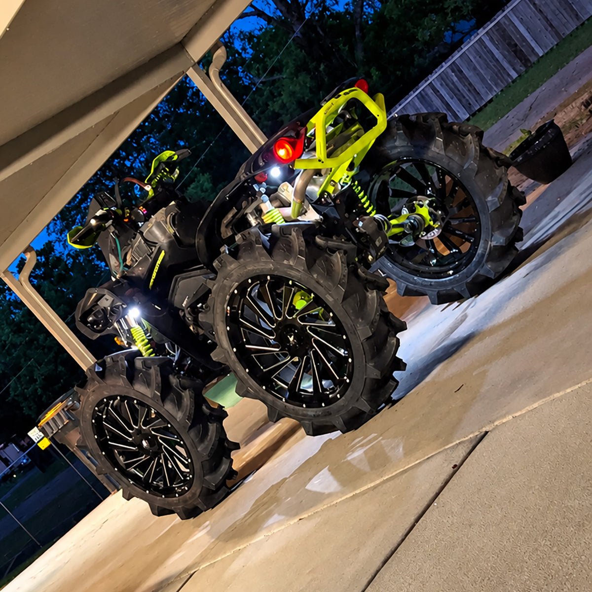 Rear angle view of a lifted Can-Am Renegade 1000R with PERFEX 2-inch lift kit, large mud tires and raised off-road stance.
