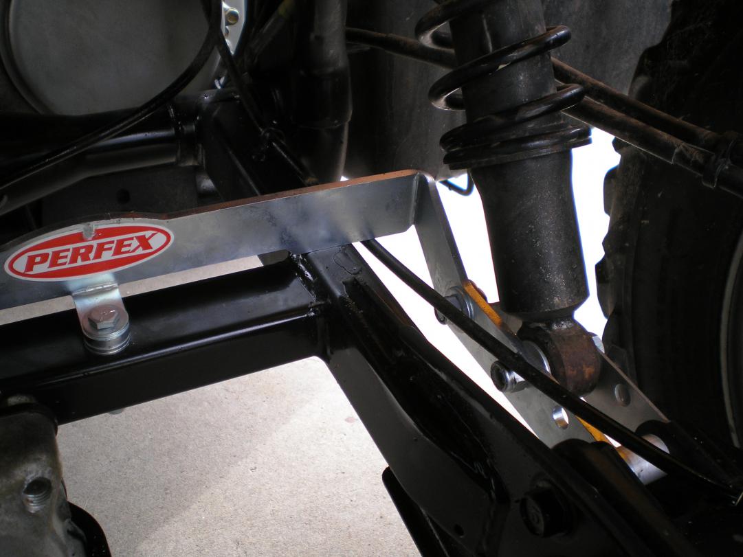 Detailed view of the bolt-on installation process for the PERFEX long travel suspension kit on a Honda Rubicon 500, highlighting the ease of setup with included hardware.