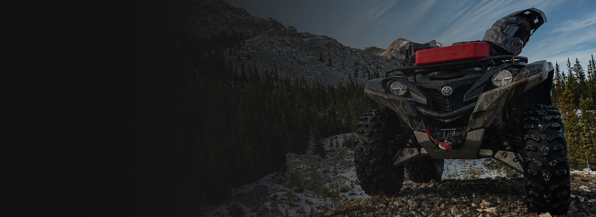 Yamaha Grizzly 700 ATV on a rocky mountain trail showcasing premium ATV & UTV accessories by PERFEX.
