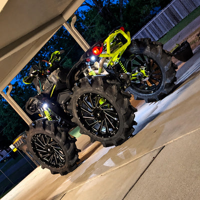 Rear angle view of a lifted Can-Am Renegade 1000R with PERFEX 2-inch lift kit, large mud tires and raised off-road stance.