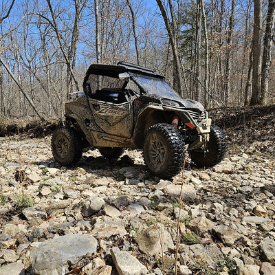 Lifted CFMOTO ZForce 950 Sport UTV with PERFEX suspension lift on rocky terrain.