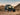 Can-Am Commander 1000 UTV, equipped with Perfex LED light, completing its desert ride against the backdrop of a sunset.
